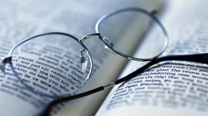Reading glasses resting on a printed letter