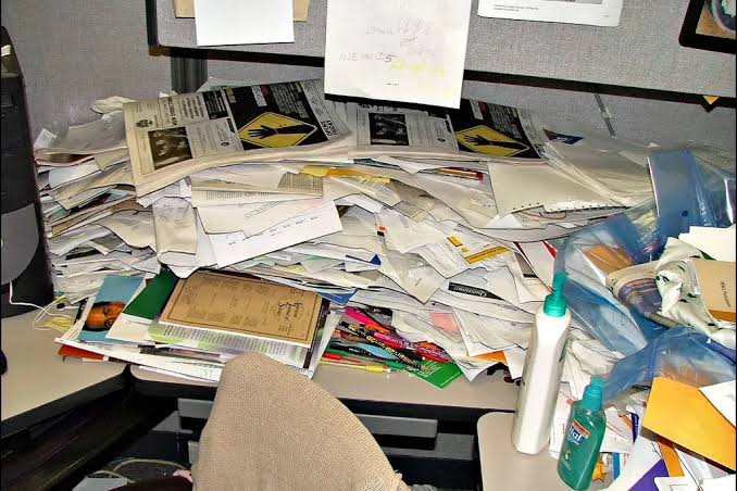 A desk with paperwork, wide and out of focus